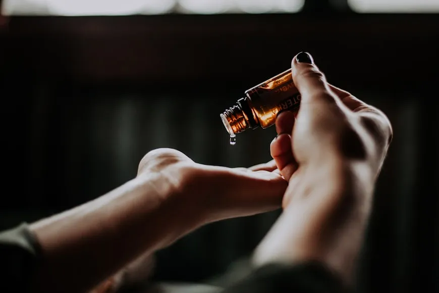 Applying natural hair oil for hair strengthening and healthy hair regrowth.