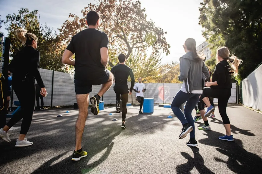 People exercising outdoors to improve overall health and support hair growth.