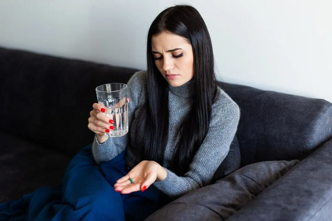 Woman Taking Iron Tablets for Hair Loss Recovery and Hair Regrowth