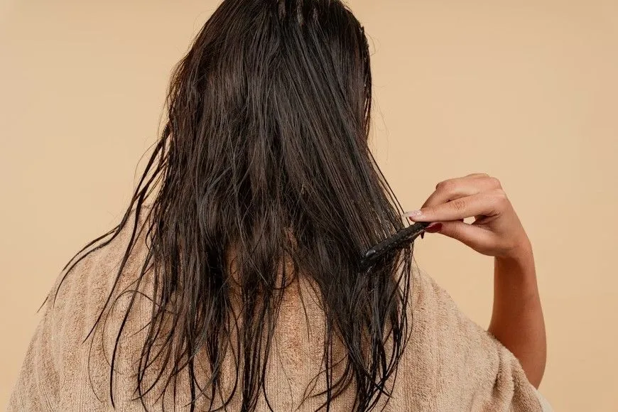 Woman experiencing hair thinning caused by PCOS related hormonal imbalance.