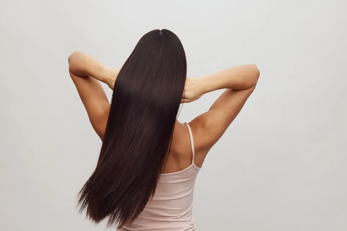 Woman Checking Hair Loss Due to PCOS Hormonal Changes